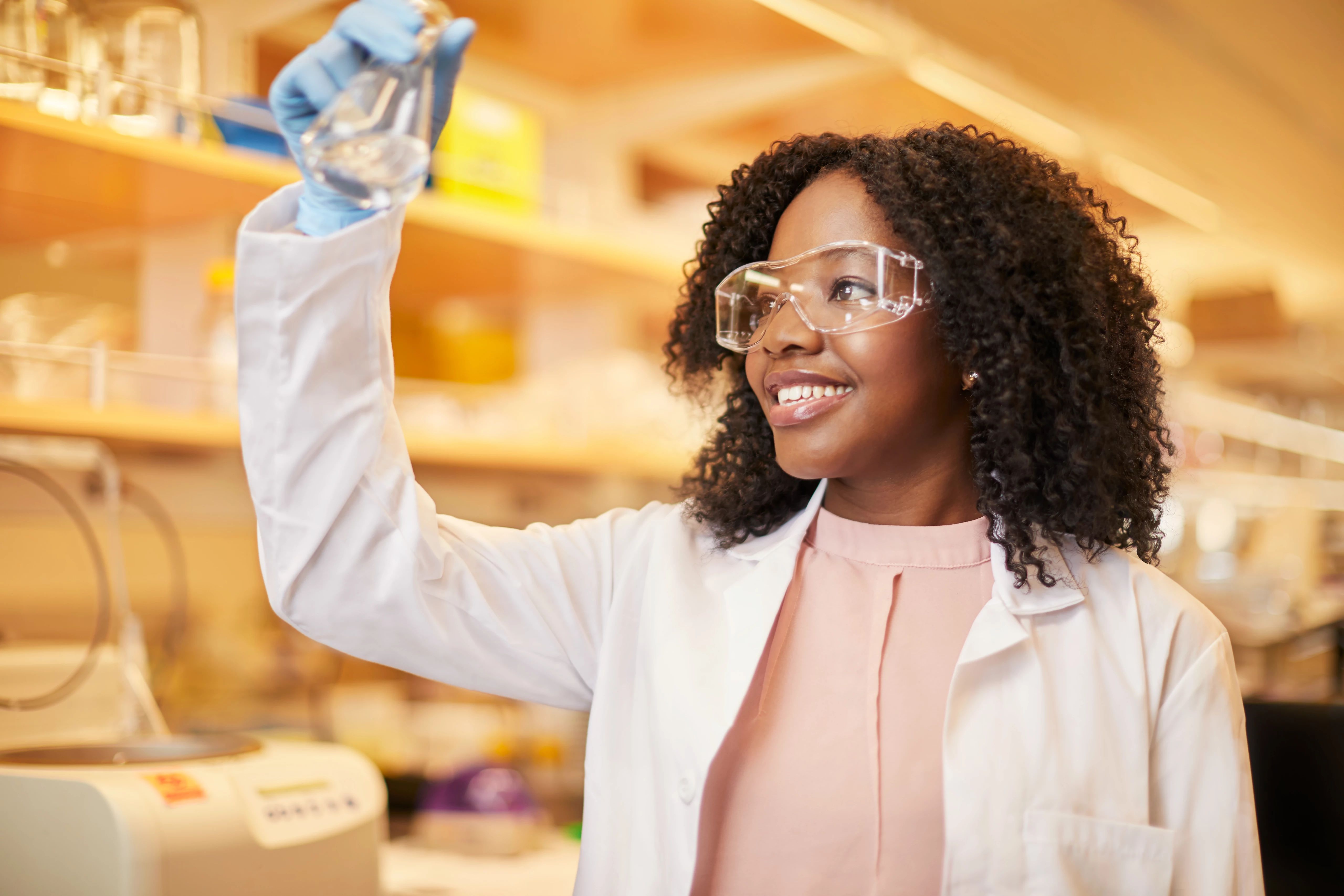 Woman in science lab holding beaker